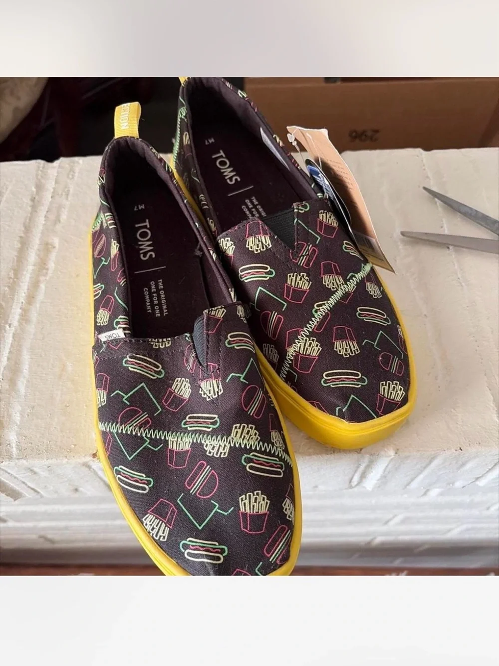 TOMS Black Slip-On Sneakers with Neon Diner Print and Yellow Sole